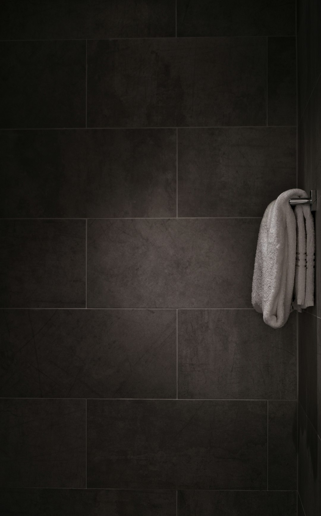 white towel in tiled bathroom