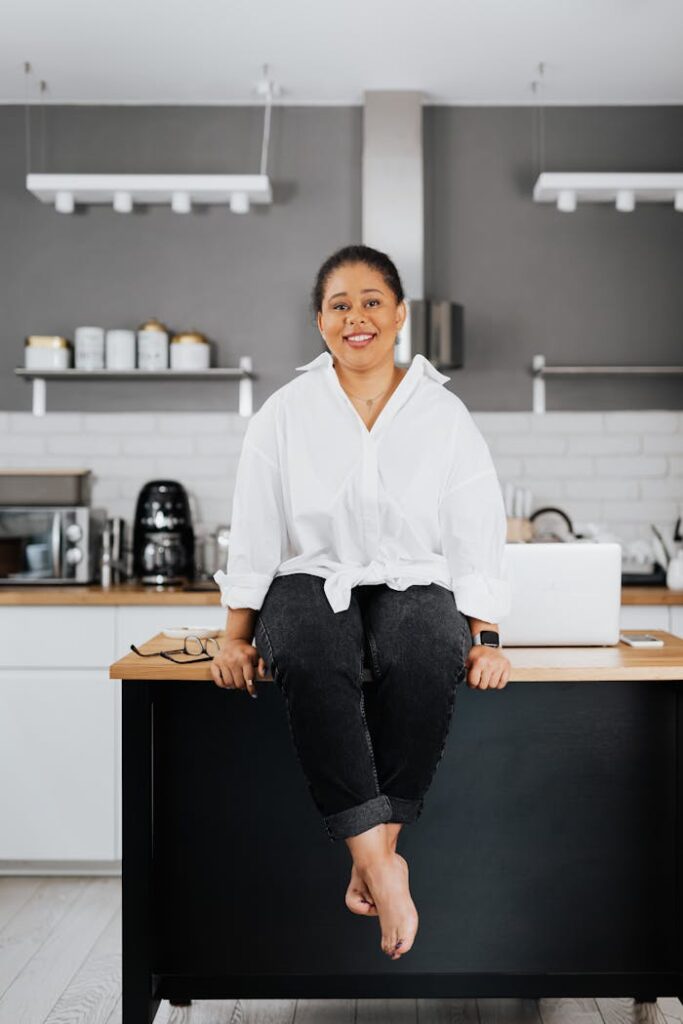 woman-sitting-on-a-kitchen-countertop-and-smiling-5386459 Woman Sitting on a Kitchen Countertop and Smiling